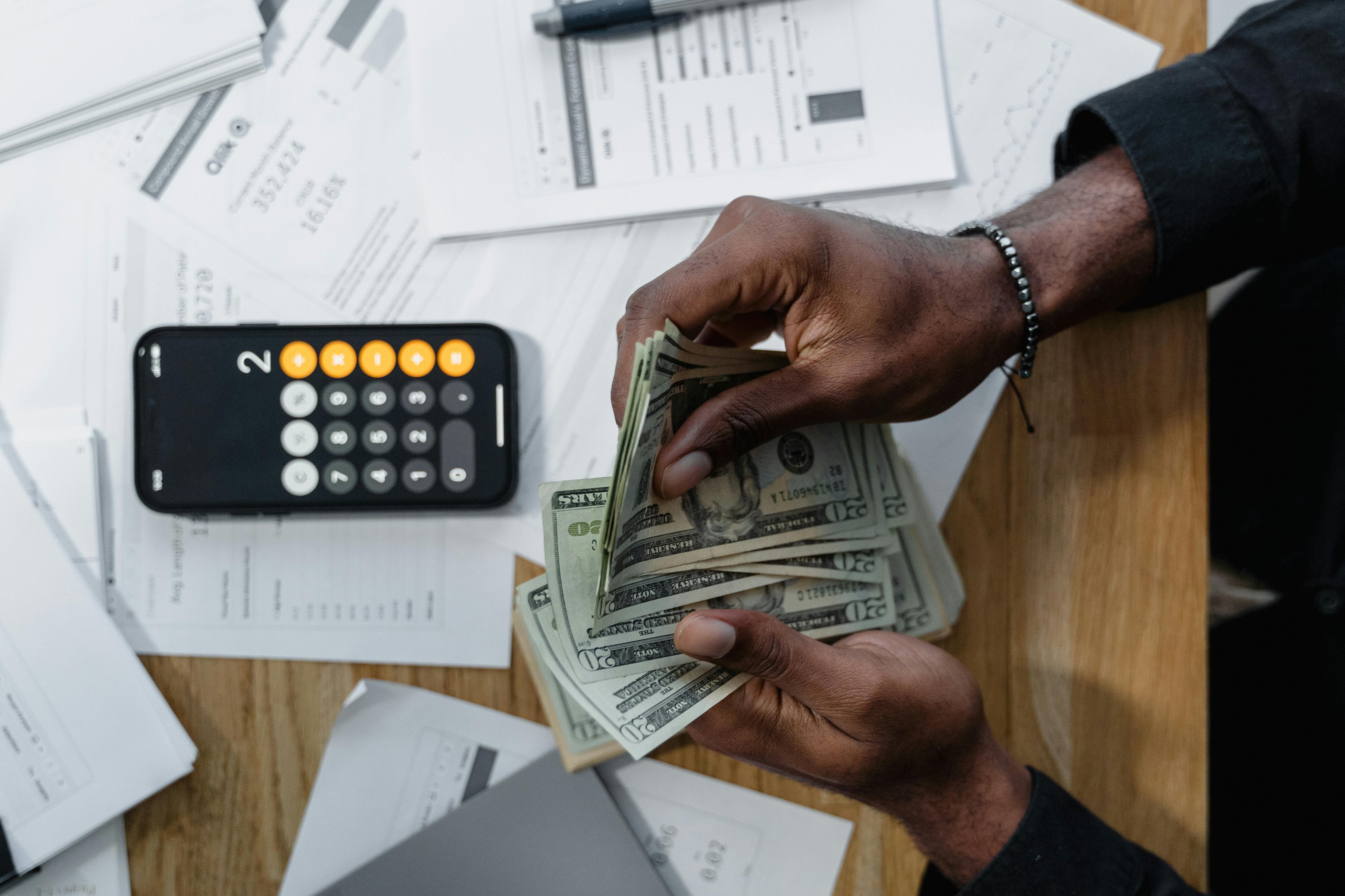 hands-counting-money-at-table